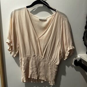 Flowy blouse with synching around the waist.